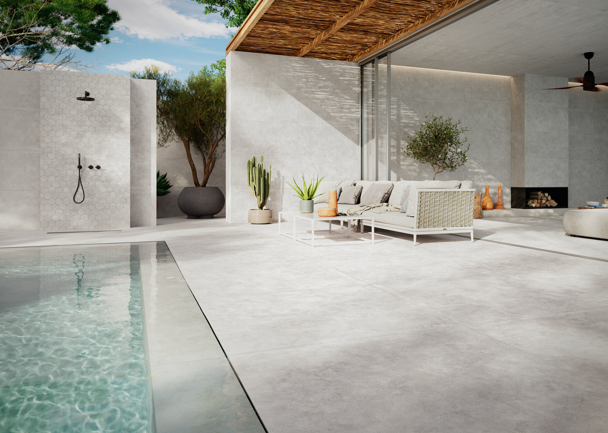 Terraza con piscina y pavimento cerámico gris de Grespania, colección Surface.